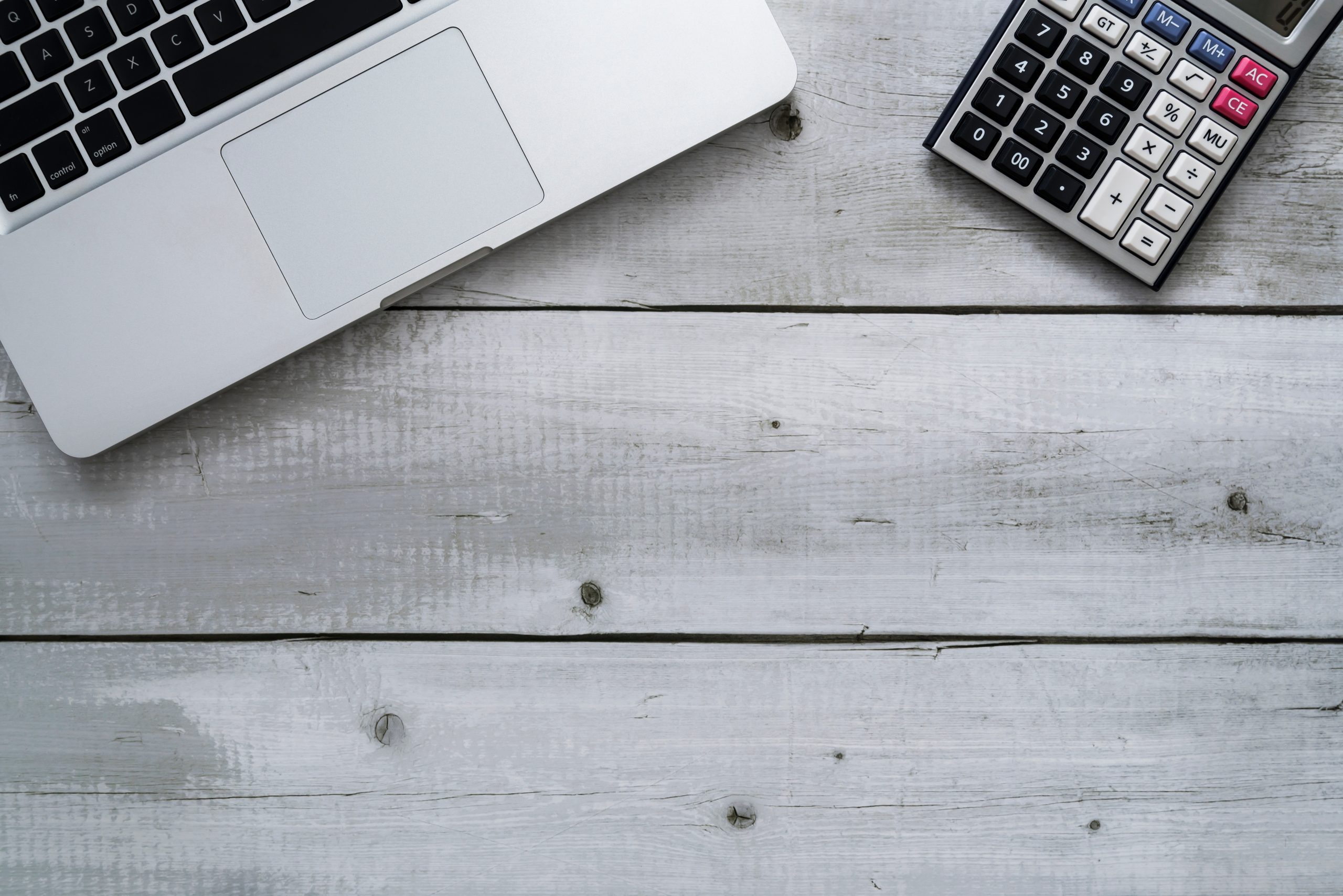 Flat,Lay,Of,Laptop,And,Calculator,On,White,Wood,With